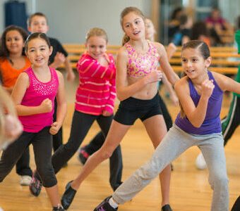 Diverse group of children taking a zumba dance fitness class Diverse group of children taking a zumba dance fitness class